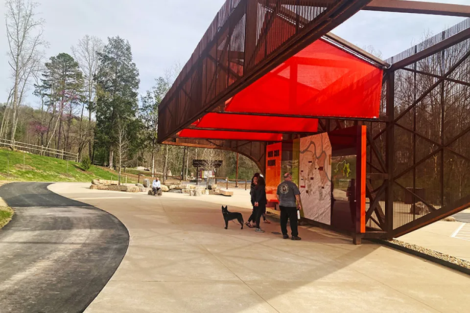 Red and black pavilion with visitor information in public park in Knoxville, Tennessee.